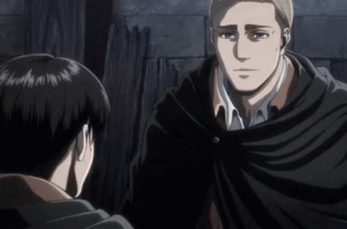 A Man In A Black Cape Talks To Another Man In A White Shirt GIF