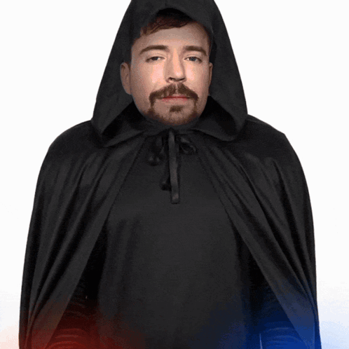 a man in a black cape with a hood is holding a red and blue light