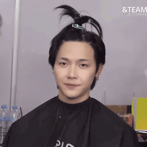 A Man In A Black Cape With The Word Team Written On The Bottom GIF