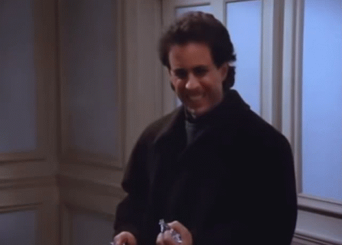 A Man In A Black Coat Is Holding A Pair Of Keys In His Hands GIF