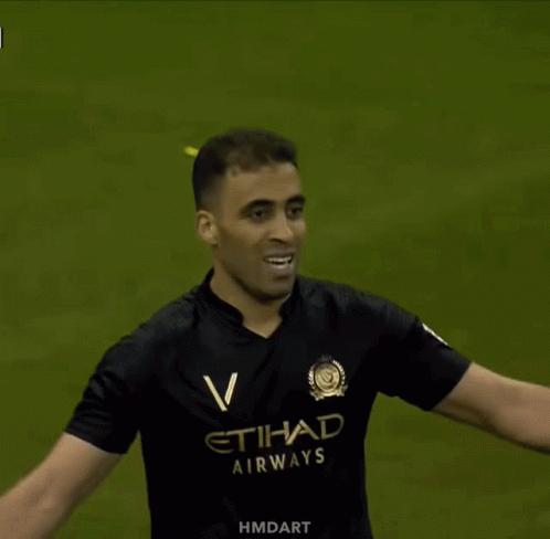 a man in a black etihad airways jersey