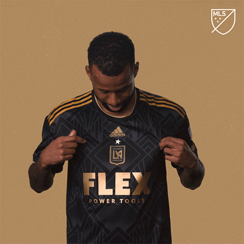 A Man In A Black Flex Power Tools Jersey GIF