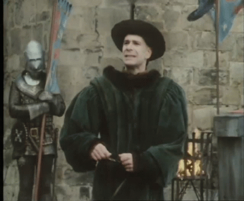 A Man In A Black Hat Is Holding A Sword GIF