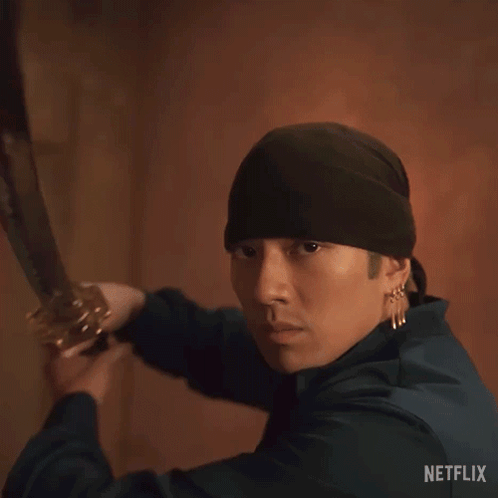 A Man In A Black Hat Is Holding A Sword With The Words " Good Sword " Above Him GIF