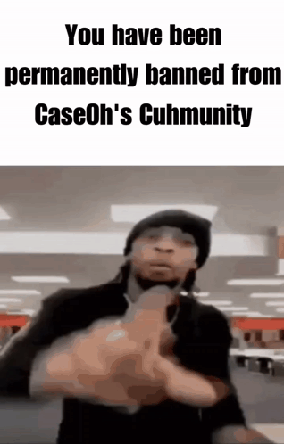 A Man In A Black Hat Is Pointing A Gun At The Camera . GIF