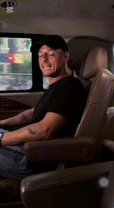 a man in a black hat is sitting in the back seat of a car .
