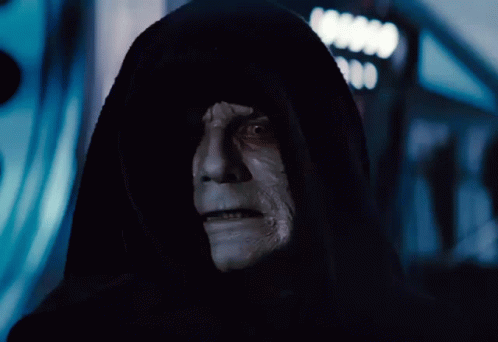 A Man In A Black Hood With A White Face And Teeth GIF