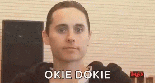 A Man In A Black Hoodie Is Making A Funny Face And Saying Okie Dokie . GIF