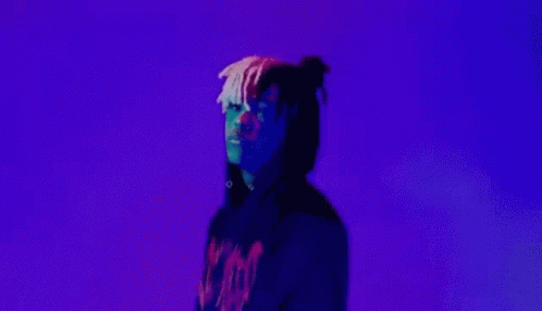 A Man In A Black Hoodie Is Making A Peace Sign With His Hands . GIF