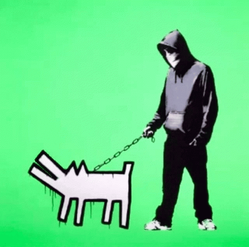 A Man In A Black Hoodie Is Walking A White Dog On A Leash GIF