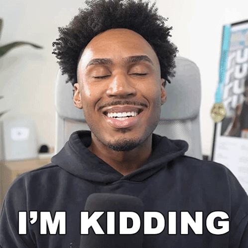 A Man In A Black Hoodie Says I 'M Kidding While Smiling GIF