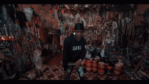 A Man In A Black Hoodie With The Letter B On The Front GIF