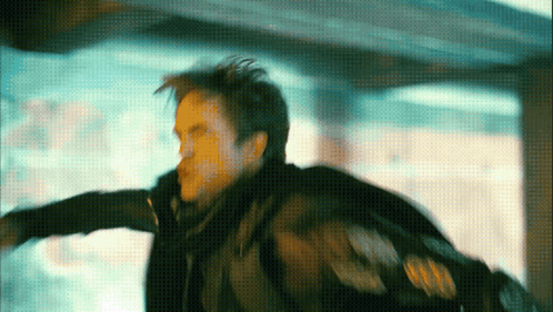 A Man In A Black Jacket Is Flying Through The Air In A Blurry Photo GIF