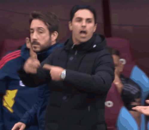 A Man In A Black Jacket Is Giving A Thumbs Up GIF