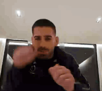 A Man In A Black Jacket Is Giving The Middle Finger GIF