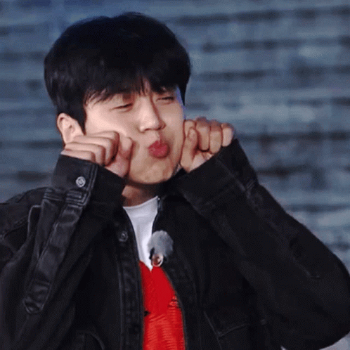 A Man In A Black Jacket Is Making A Funny Face With His Hands GIF