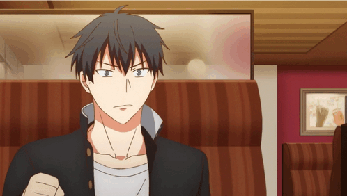A Man In A Black Jacket Is Sitting In A Striped Chair GIF