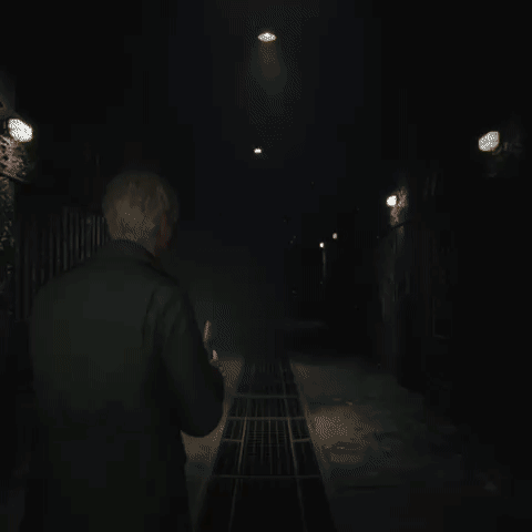 A Man In A Black Jacket Is Standing In A Dark Room GIF