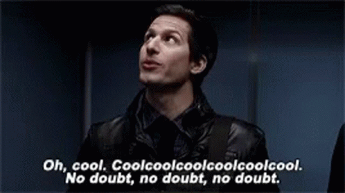 A Man In A Black Jacket Is Standing In Front Of A Blue Wall And Talking . GIF