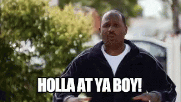A Man In A Black Jacket Is Standing In Front Of A Car And Says Holla At Ya Boy . GIF