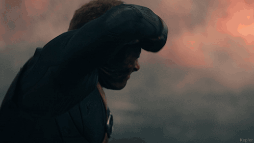 A Man In A Black Jacket Is Standing In Front Of A Cloudy Sky With Kepler Written On The Bottom GIF