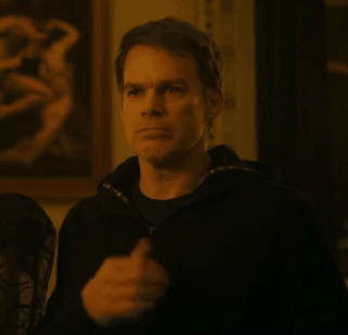 A Man In A Black Jacket Is Standing In Front Of A Painting In A Room . GIF