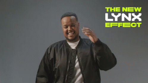 A Man In A Black Jacket Is Standing In Front Of A Sign That Says " The New Lynx Effect " GIF