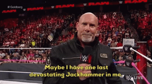 A Man In A Black Jacket Is Talking Into A Microphone And Says " Maybe I Have One Last Devastating Jackhammer In Me " GIF