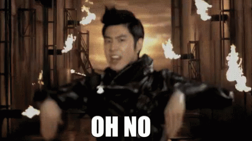 A Man In A Black Jacket Says Oh No In Front Of Fire GIF