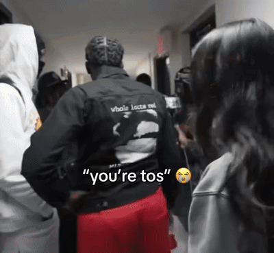 A Man In A Black Jacket Says " You 'Re Tos " To A Woman GIF