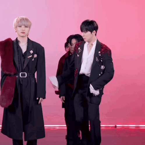 A Man In A Black Jacket With A Red Fur Collar GIF