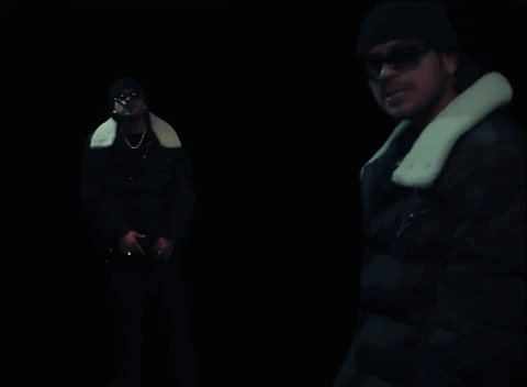 A Man In A Black Jacket With A White Fur Collar GIF