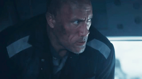A Man In A Black Jacket With A White Stripe On The Sleeve Is Looking Down GIF