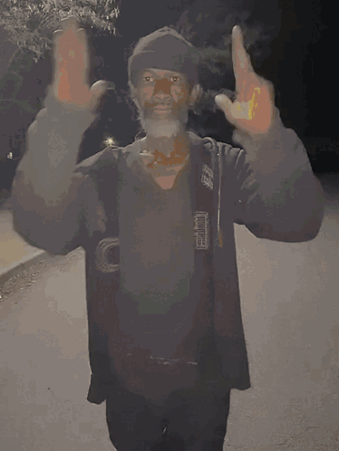 A Man In A Black Jacket With The Letter O On His Chest GIF