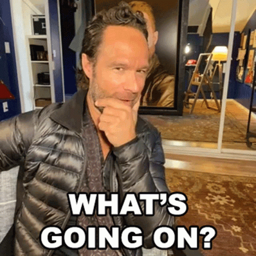 A Man In A Black Jacket With The Words What 'S Going On Behind Him GIF