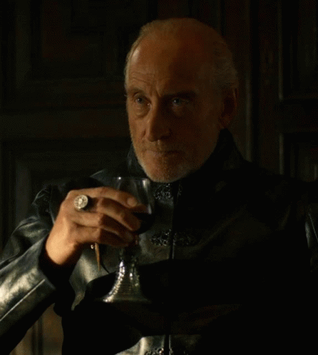 A Man In A Black Leather Jacket Holds A Glass Of Wine GIF