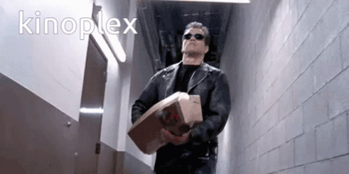 A Man In A Black Leather Jacket Is Carrying A Bag Of Mcdonald 'S Chicken GIF