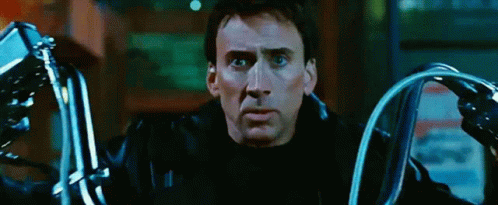 A Man In A Black Leather Jacket Is Holding A Pair Of Motorcycle Handlebars GIF