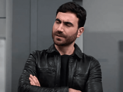 A Man In A Black Leather Jacket Is Making A Face GIF