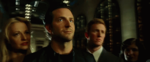 A Man In A Black Leather Jacket Is Standing In A Crowd Of People GIF