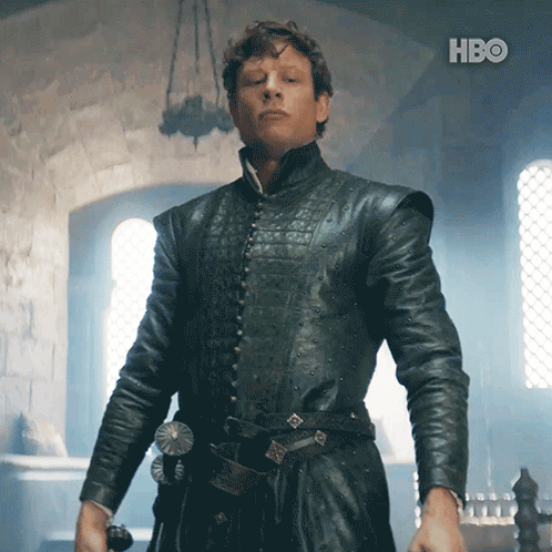 A Man In A Black Leather Jacket Is Standing In Front Of A Hbo Logo GIF