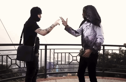 A Man In A Black Mask Is Giving A High Five To Another Man In A White Shirt GIF