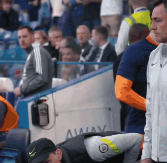 A Man In A Black Nike Hat Is Looking Down GIF