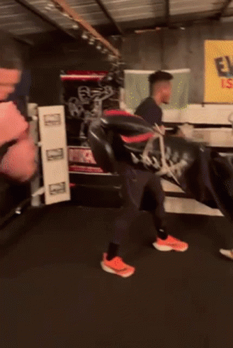 A Man In A Black Nike Shirt Is Boxing GIF