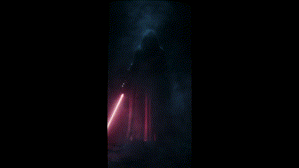 A Man In A Black Robe Holding A Red Light Saber GIF