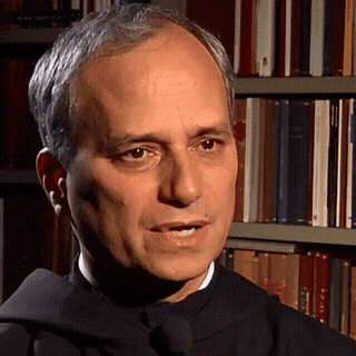 A Man In A Black Robe Stands In Front Of A Bookshelf With A Book Titled ' A Brief History ' On It GIF