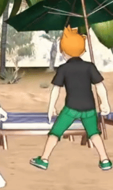 a man in a black shirt and green shorts is standing under an umbrella on a beach .