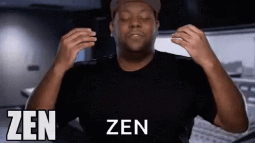 A Man In A Black Shirt And Hat Is Making A Zen Gesture With His Hands . GIF