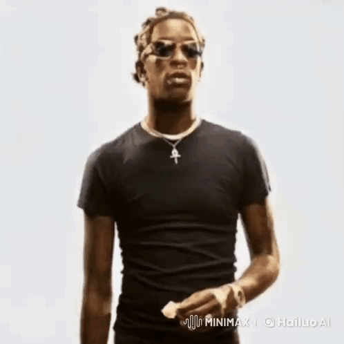 A Man In A Black Shirt And Sunglasses Is Holding A Piece Of Paper . GIF