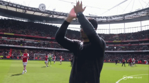 A Man In A Black Shirt Applauds The Crowd At A Soccer Game Sponsored By Bt Sport Hd Live GIF